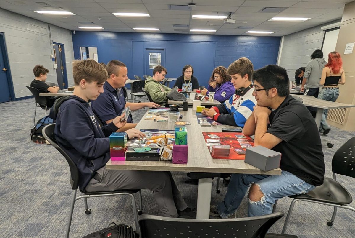 The Tabletop Gaming Club utilizing the East Campus Collaboration Center after school.  Front left, Nathan Lamb (LP ‘24); back left, Mr. Foleno; back right, Jack Kaemerer (LP ‘24); front right, Alex Navarette (LP ‘24).