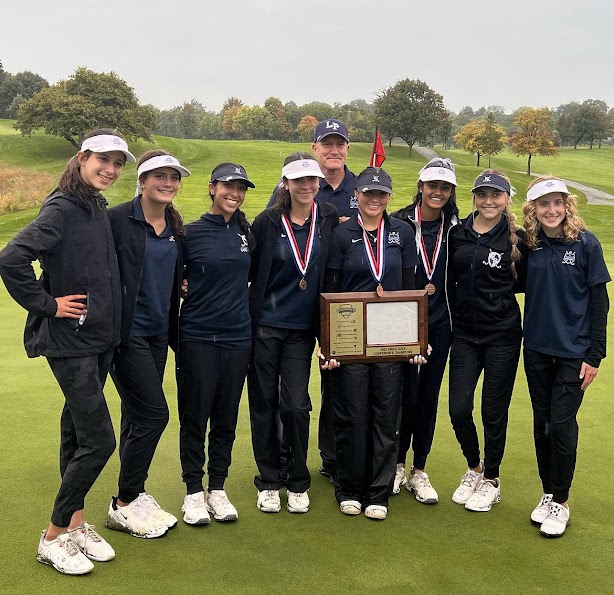 Girl’s Golf poses with their conference championship plaque after their win at the conference championship.