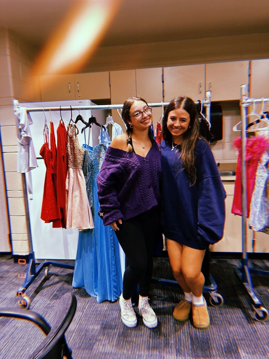 Gracie Pendola and Liliana Alarcon pose in front of a rack of dresses made accessible to students. 
Photo courtesy Liliana Alarcon
